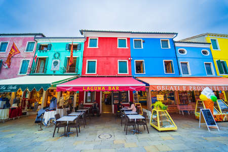 View of streets with colorful houses in Burano along canal. Typical tourist place - burano island in the Venetian lagoon Italy. Beautiful water canals and colorful architecture. Burano. Italyのeditorial素材