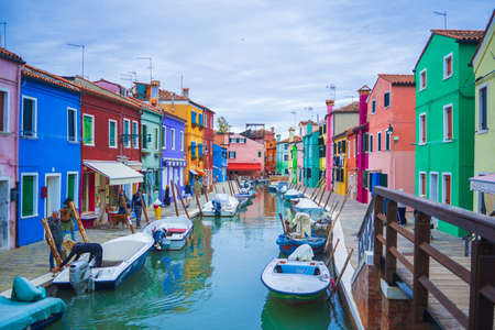 View of streets with colorful houses in Burano along canal. Typical tourist place - burano island in the Venetian lagoon Italy. Beautiful water canals and colorful architecture. Burano. Italyのeditorial素材