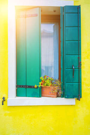 Typical tourist place burano island in Venetian lagoon Italy. Beautiful water canals and colorful architecture. Colorful wall with windows with shutters. architecture in Burano island.の写真素材