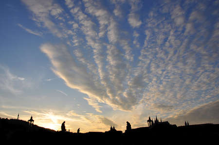 Beautiful sunset skies with clouds over Charles Bridge silhouette in Pragueの写真素材