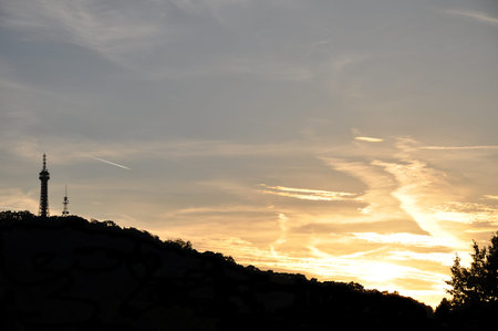 Scenic view with afterglow skies over the hill and TV tower dark silhouettes