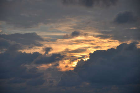 Dramatic cloudscape with the last golden rays of the evening sunの写真素材