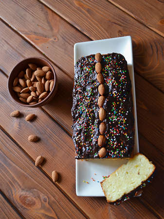 Home baked almond cake with cottage cheese, glazed with chocolate, on the wooden tableの写真素材