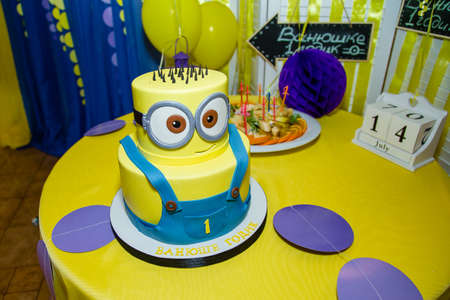 Izmail, Ukraine - 2016. Editorial use. Birthday cake in minion shape. Cartoon character cake for child party. Thematic event. Candy bar.のeditorial素材