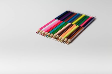 Double sided coloring pencils on white background, copy spaceの写真素材