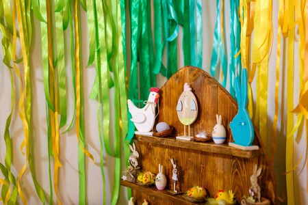 Easter decorative elements, painted eggs, wooden hen, bunny and chicken toysの写真素材