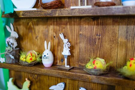 Easter decorative elements, painted eggs, wooden hen, bunny and chicken toysの写真素材