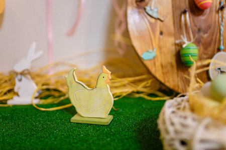 Easter hen and bunny toys on green artificial lawn background. Spring decorative elements, Easter concept.の写真素材