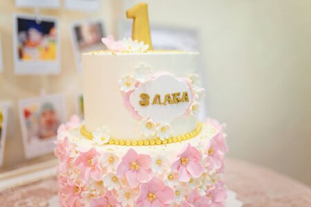 Girlish cake with pink cream flowers and number 1. One year old first birthday party. の写真素材