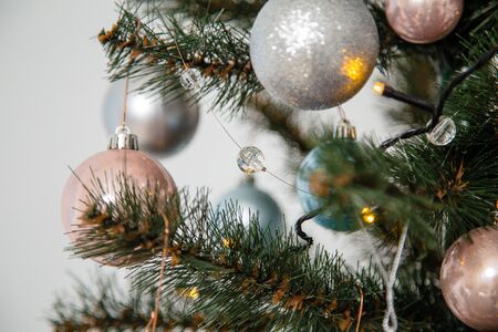 decorated fir tree with pink, blue, white and silver bulbs. Merry Christmas, Happy New Year and winter holidays concept. の写真素材