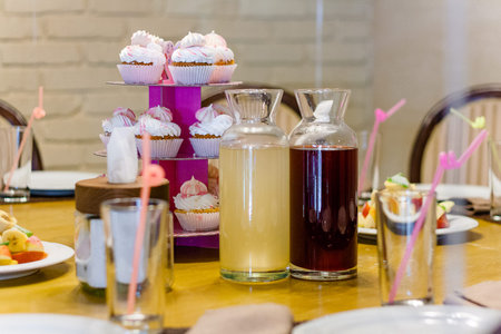 Candy bar with sweet cup cakes and drinks for child birthday party