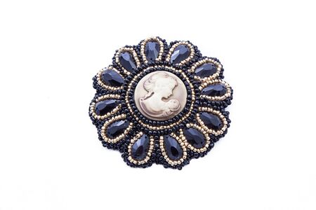Beads handmade brooch with female portrait isolated on white background. Female accessories, decorative ornaments and jewelry. Fashion and style concept.の写真素材