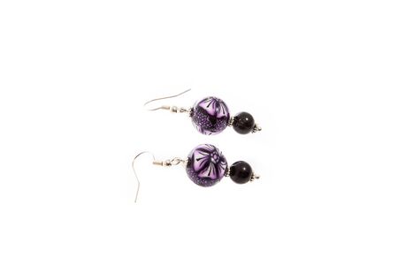 Handmade round earrings isolated on white background. Female accessories, decorative ornaments and jewelry. Fashion and style concept.の写真素材