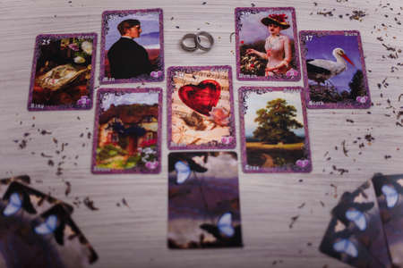 Divination cards alignment in the heart shape for love and family. Men and women relationships, astrology, fortune telling and belief concept.の写真素材
