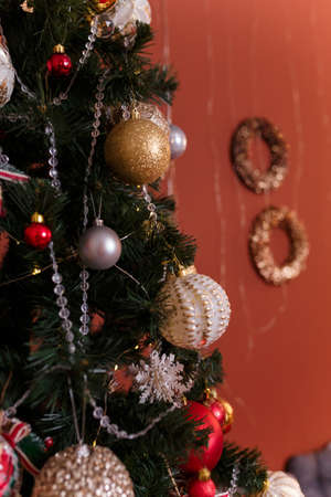 Close up of fir-tree branches decorated with baubles and garlands. Winter holidays, magic, Merry Christmas, Happy New Year concept.の写真素材