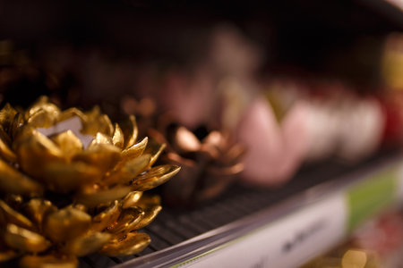 Ceramic pink and golden decorative flowers, soft focused close up shot. Decorations in the shop or supermarket.の写真素材
