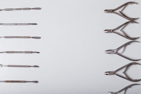 Manicure, pedicure equipment set on white background, top view. Disinfected instruments for safe hygiene, beauty and hands care. Top view. Copy space.の写真素材