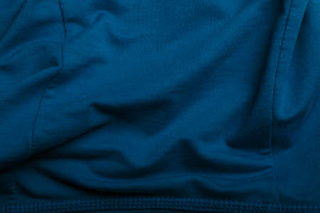 Texture of blue cotton wrinkled fabric, background or backdrop. Clothing, sewing, gressmaking, haberdashery. Copy space.の写真素材