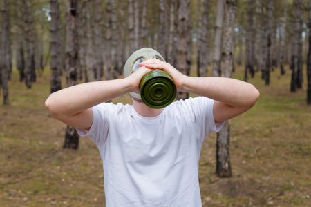 Man taking off gas mask in pine forest. Enviromental protection, ecology, Earth saving, pollution...