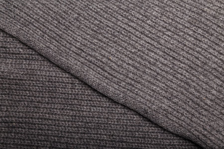 Knit gray fabric texture, background or backdrop. Textile, scarf or sweater textured surface. Warm...