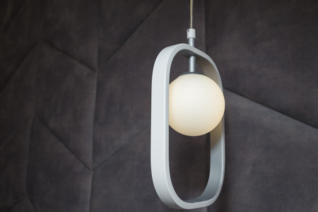 Modern lit, white lamp, illuminator with geometry oval decorative element, soft fabric head of bed,...