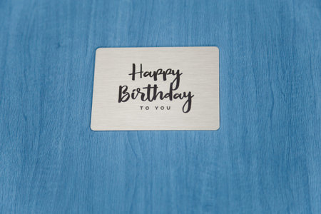 Photobook, photoalbum in blue leather cover with metallic shield and inscription Happy Birthday to...