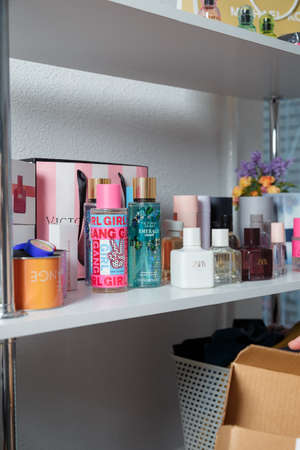Izmail, Ukraine. May 2021. Perfume bottles on shelf with other cosmetics. Fragrance, Beauty concept. vertical shotのeditorial素材