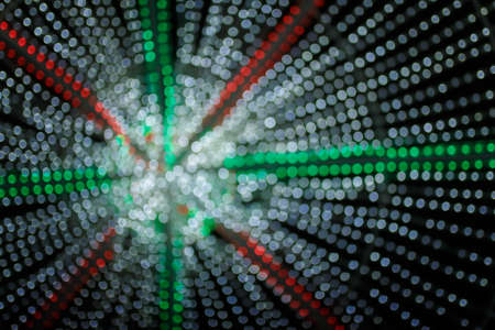 Unfocused night shot of Christmas garland lights bokeh in the city. Happy New Year, Merry Christmas, winter holidays concept.の写真素材