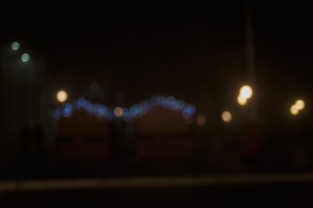 Unfocused night shot of Christmas garland lights bokeh in the city. Happy New Year, Merry Christmas,...