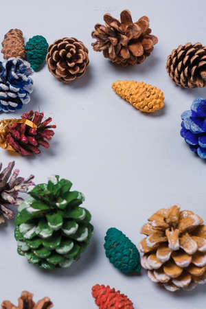 Eco friendly Christmas, New Year decorations, multicolored painted natural pine, fir cones, no plastic concept. Copy space.の写真素材