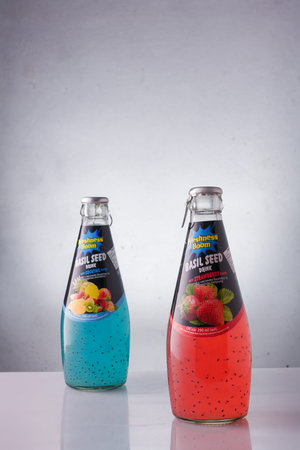 Izmail, Ukraine. June 2021. Freshness boom Basil seed drinks with cocktail and strawberry flavor. Bottles of sweet juice on white background.のeditorial素材