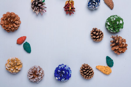 Eco friendly Christmas, New Year decorations, multicolored painted natural pine, fir cones, no plastic concept. Copy space.の写真素材