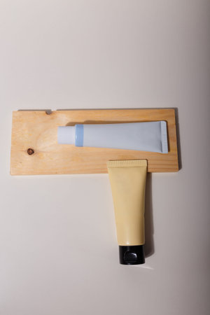 Two beige blue mockup tubes, no brand label on white table. Template, copy space. Face skin care cosmetics, nourishing creme, clay maskの写真素材