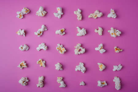 Popcorn lay out on pink background, top viewの写真素材