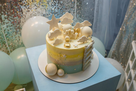 Birthday cake for 1 year old baby boy. Cake with star, clouds toppers, balls, teddy bear and ladder