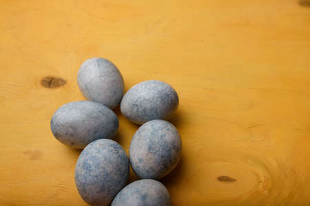 Easter in Ukraine 2022. Ukrainian flag colors: blue painted Easter eggs on yellow background. Copy space, top viewの写真素材