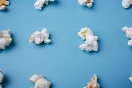 Popcorn lay out on blue background, close up shot. Food patternの写真素材
