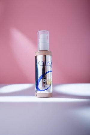 izmail, Ukraine. May 2022. Enough Collagen Moisture Foundation with SPF 15. Care cosmetics bottle on pink backgroundのeditorial素材