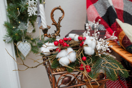 Christmas floral composition, bouquet from fir branches, red berries and white cotton flowers....