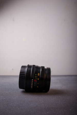 Izmail, Ukraine. April 2022. USSR Helios lens for photo camera on grey background. Old photo...