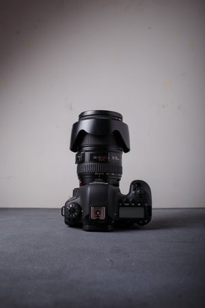 Izmail, Ukraine. April 2022. Canon EOS photo camera witj L series zoom lens 24-105 mm on grey background, copy spaceのeditorial素材