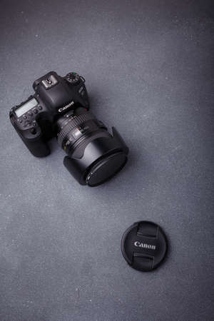 Izmail, Ukraine. April 2022. Canon EOS photo camera with L series zoom lens 24-105 mm on grey background, copy spaceのeditorial素材