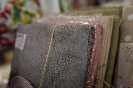 Soft focused close up shot of several table clothes in plastic packages on supermarket shelf