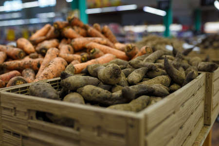 Fresh carrots and beetroots in boxes in grocery department store, local shop, supermarket. Organic food, farm vegetablesの写真素材