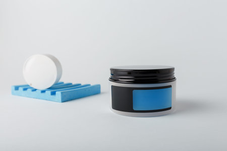 Cream container with empty blue label, mock up template on white background. Face and body skin care...
