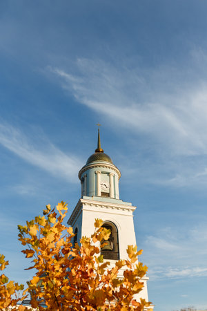 Izmail, Ukraine. September 2021. The Orhtodox Saint-Pokrov cathedral church. Historic architecture with golden yellow tree on blue sky backgroundのeditorial素材