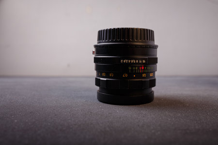 Izmail, Ukraine. April 2022. USSR Helios lens for photo camera on grey background. Old photo equipment, lens brandのeditorial素材