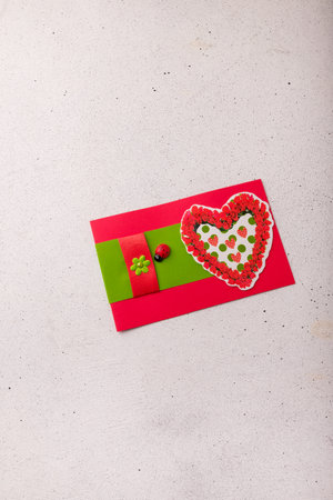 Izmail, Ukraine. 14 February 2022. Valentines day postcard with red heart, flowers and ladybug on white backgroundのeditorial素材