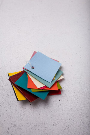 Multicolored leather samples, catalog or collection of examples on light background. Cover of album,...