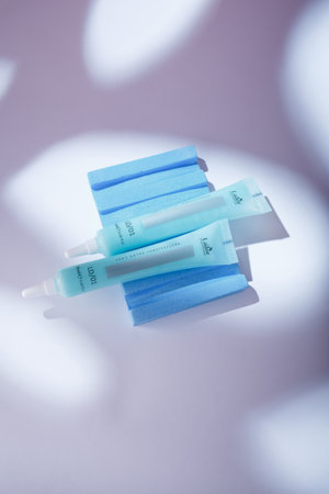 Izmail, Ukraine. May 2022. Lador Eco Professional Salon Care hair mask-filler in blue tube on white background in harsh light. Korean cosmeticsのeditorial素材